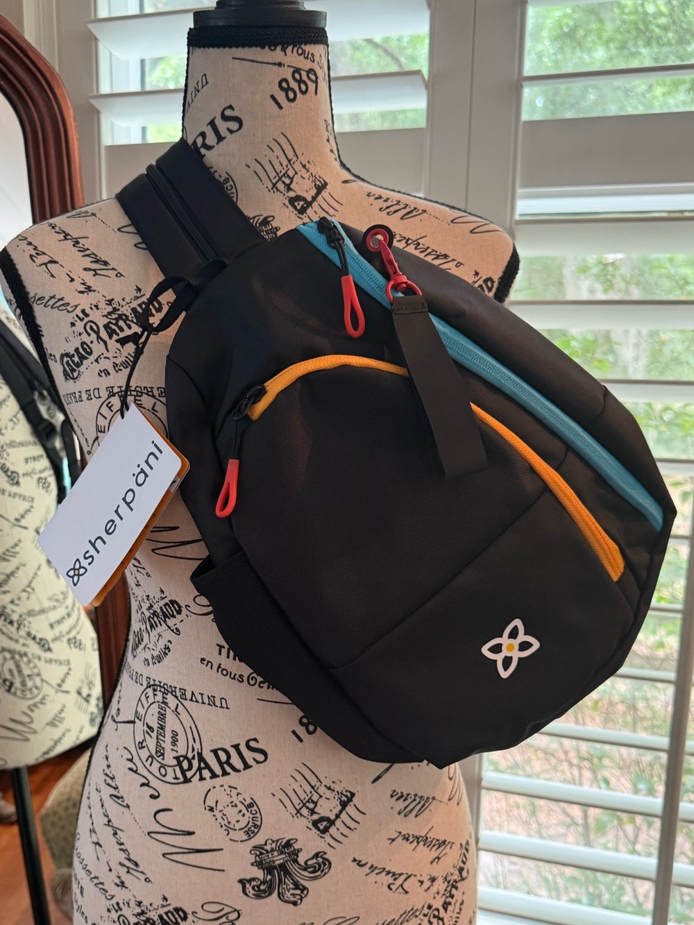 Sherpani Black Sling Bag with Blue and Yellow Accents